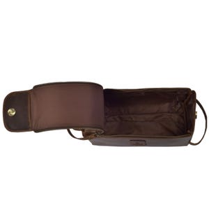 May include: Open, brown leather toiletry bag with a zippered main compartment and a smaller, zippered side compartment. The bag has a handle and a snap closure. The interior is lined with a brown fabric.