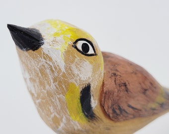 Handmade wooden bird on the base. colorful sculpture, wooden gift, wooden decoration, brown and yellow bird with white and black accents