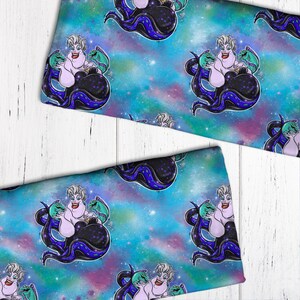 May include: A blue and purple galaxy print fabric featuring a repeating pattern of Ursula from The Little Mermaid. Ursula is depicted with her signature purple hair and green eels.