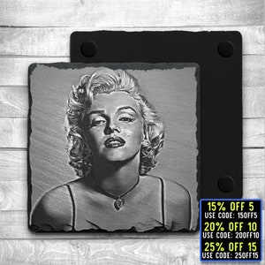 May include: Black and white engraved image of Marilyn Monroe on a square slate coaster. The coaster has a black backing. The image is of Monroe's face and shoulders, with her hair styled in a classic blonde updo. She is wearing a simple black dress with a heart-shaped pendant necklace. The text below the image reads: "15% OFF 5 USE CODE: 150FF5 20% OFF 10 USE CODE: 200FF10 25% OFF 15 USE CODE: 250FF15"