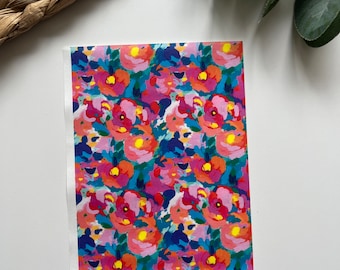 May include: A rectangular print with a colourful floral design. The pattern features flowers in shades of pink, orange, yellow, and blue, creating a lively and artistic aesthetic. The print has a white border.