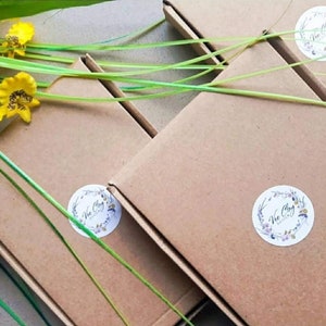 May include: Four brown cardboard boxes with a white circular logo that says "Vee Clay Designs" on each box. The boxes are stacked on top of each other.