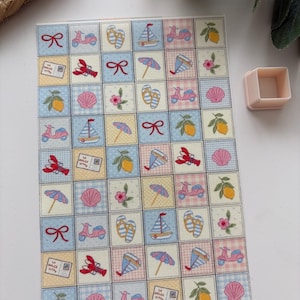 May include: A sheet of decorative stickers featuring a repeating pattern of summer-themed illustrations. The design includes scooters, sailboats, lemons, seashells, and bows, set against a checkered pastel background.