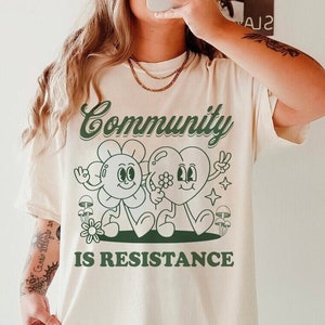 Community is resistance shirt | leftist | liberal democrat | political | retro cottagecore | feminist | activism | anti capitalism | housing