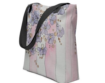 May include: A white tote bag with pink and white stripes and a floral design featuring purple flowers and gold dots.