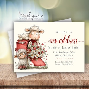 May include: A cream-colored card with a red mailbox overflowing with flowers and two cartoon sheep. The text "WE HAVE A new address" is in red script. Below is the address and contact information.