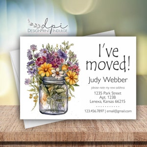 May include: A white card with a watercolor illustration of a mason jar filled with wildflowers. The card says "I've moved!" and includes the sender's name, new address, phone number, and email address.