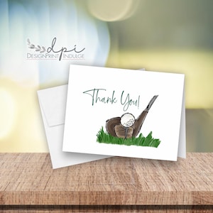 May include: A white thank you card with a green and brown illustration of a golf club and golf ball. The text "Thank You!" is written in green.
