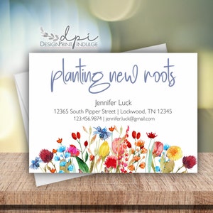 May include: A white business card with a watercolor floral border. The text "planting new roots" is in blue script. The card includes the name "Jennifer Luck", an address, phone number, and email address.