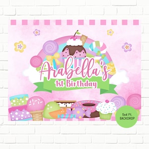 May include: A pink and green 5x4 ft. backdrop with a candy theme. The backdrop features a cupcake, lollipops, donuts, and other sweets. The text "Arabella's 1st Birthday" is written in a pink and green font.