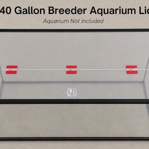May include: A rectangular 40 Gallon Breeder Aquarium Lid with a black frame, clear panels, and three bright red hinges connecting the two sections. A small, clear circular handle is attached to the front panel. Text reads 40 Gallon Breeder Aquarium Lid.