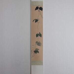 May include: A set of three ceramic vases in varying heights. The vases have a matte finish in shades of cream, beige, and brown. The tallest vase is approximately 10 inches tall.