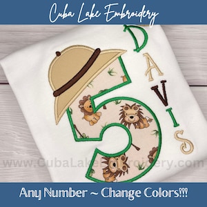 May include: Green embroidered number five with a safari theme. The number is surrounded by small embroidered lions and green leaves. A brown embroidered hat is on top of the number. The name "DAVIS" is embroidered in brown to the right of the number. The text "Any Number ~ Change Colors!!!" is at the bottom of the image.