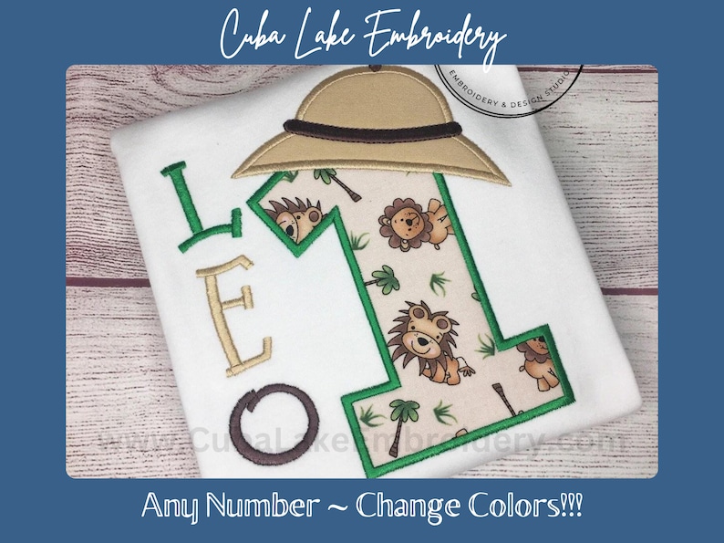May include: Embroidered design of the letter "L" with a safari hat, a number "1" with a jungle animal print, and the text "Any Number ~ Change Colors!!!".