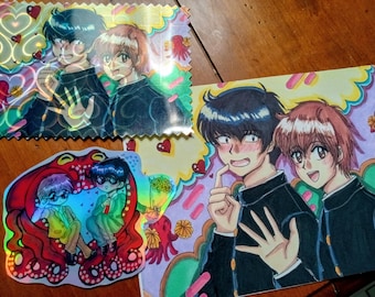 May include: A collection of anime-style illustrations featuring two characters with dark and light hair in school uniforms. The set includes a rectangular holographic print, a smaller die-cut holographic sticker, and a larger rectangular paper print.