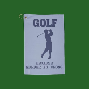 May include: A light blue golf towel with the word "GOLF" above a silhouette of a golfer swinging a club. Below the golfer, the text reads "BECAUSE MURDER IS WRONG". The towel has a gold-colored grommet.