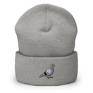 May include: Grey beanie with a grey embroidered pigeon on the front.
