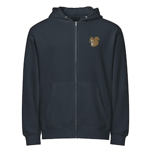 May include: Navy blue zip-up hoodie with a hood and front pockets. A small embroidered squirrel holding a nut is on the upper left chest. The hoodie is made of a soft material.
