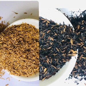 May include: Two bowls of brown rice husk, one bowl is filled with natural brown rice husk, the other bowl is filled with black rice husk.