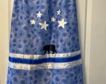 Teen traditional Metis ribbon skirts blue sunflowers with satin ribbons, it has stars and bear design. Handmade with love.