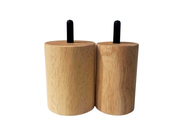 May include: Two wooden furniture legs with black rubber tips. The legs are cylindrical and have a natural wood finish.