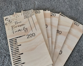 May include: A set of six wooden growth charts with the text "The Brown Family" and names "Maverick, Oliver, River" and numbers 200, 80, 60, 30, 20, and 10.