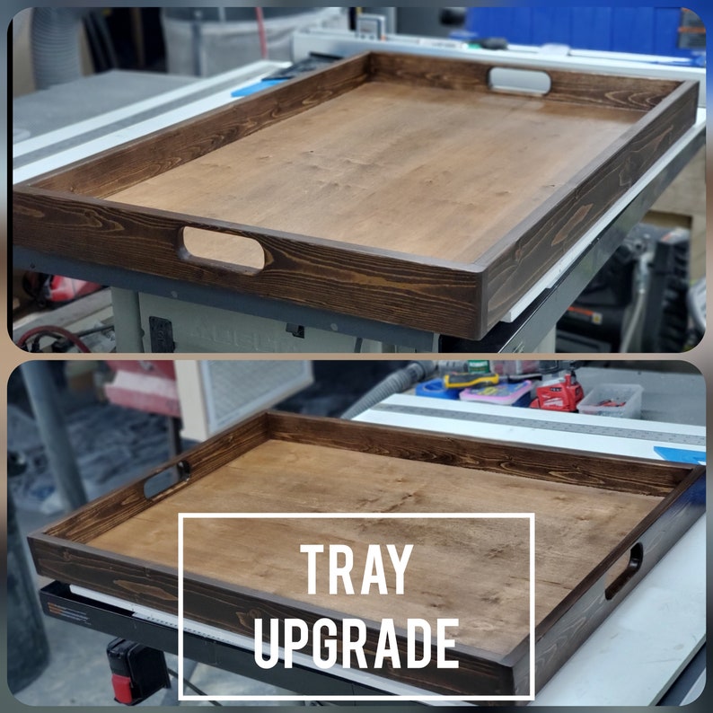 May include: A dark brown wooden serving tray with two handles. The tray is made of wood with a natural grain pattern. The text "TRAY UPGRADE" is printed on the tray.