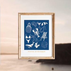 May include: A blue and white illustration of various beach-themed items, including a beach bag, a lobster, a seashell, a starfish, a swimsuit, a whale, a wave, a cocktail, an umbrella, and a beach chair. The text "meet me at the beach" is written in gold at the bottom of the illustration.