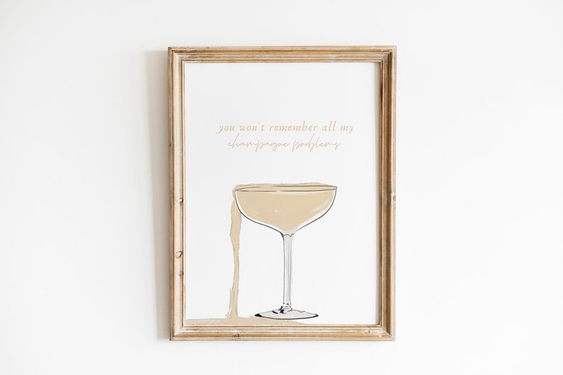 May include: A framed print with a champagne glass and the text "you won't remember all my champagne problems".