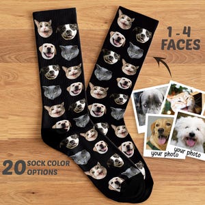 May include: A pair of black crew socks featuring a repeating pattern of various dog and cat faces. The image includes text stating 1-4 FACES and 20 SOCK COLOR OPTIONS, alongside four square photographs of pets with the text your photo printed below.