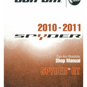 Puede incluir: Un manual de taller Can-Am Roadster para el modelo Spyder RT 2010-2011. La portada presenta el logotipo de Can-Am, el logotipo de BRP y el nombre del modelo en texto naranja. El fondo es un degradado de marr&oacute;n y blanco.