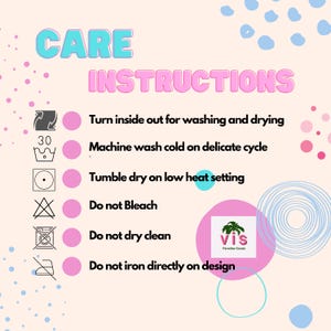 May include: Pink and blue care instructions for a garment. The instructions include turning the garment inside out for washing and drying, machine washing cold on delicate cycle, tumble drying on low heat, not bleaching, not dry cleaning, and not ironing directly on the design.