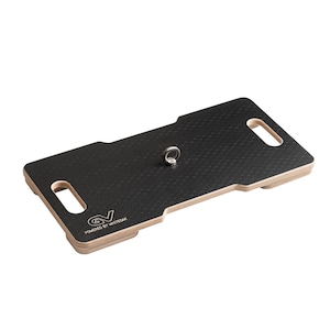 May include: A black rectangular board with a textured surface and a silver ring in the center. The board has cut-out handles on each end and the text "GV Powered by Whiteoak" printed on the bottom left corner.