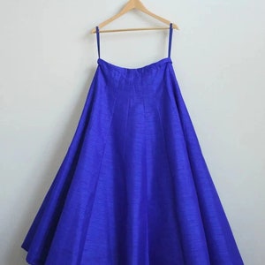May include: A royal blue floor-length skirt with a gathered waistline and a flowing silhouette.