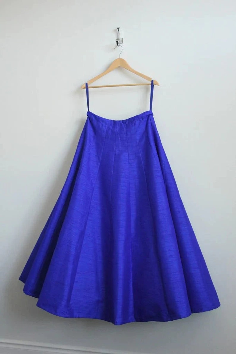May include: A royal blue floor-length skirt with a gathered waistline and a flowing silhouette.