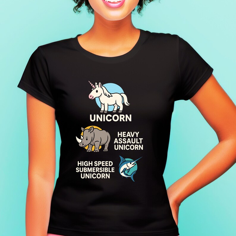 May include: Black t-shirt featuring three unicorn-themed illustrations. The shirt includes a white unicorn, a rhino labeled "Heavy Assault Unicorn," and a marlin labeled "High Speed Submersible Unicorn." The word "UNICORN" is printed above the first image.