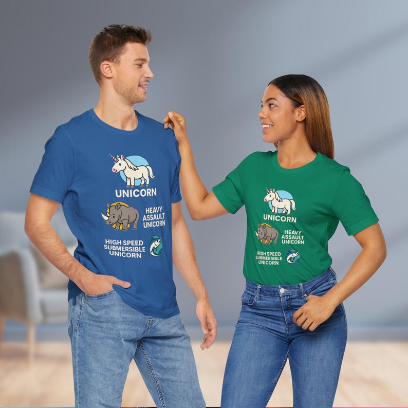 May include: Two people wearing blue and green t-shirts with a unicorn graphic. The shirts have the word "UNICORN" above a cartoon unicorn, a rhino, and the words "HEAVY ASSAULT UNICORN" and "HIGH SPEED SUBMERSIBLE UNICORN".