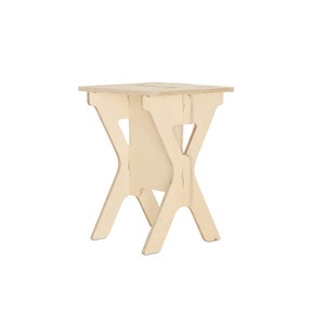 May include: A light wood folding stool with a simple design. The stool is made of plywood and has a natural finish.