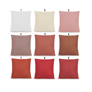 May include: Nine square throw pillows in various colors, including white, cream, pink, brown, red, and orange. The pillows are numbered 1 through 9.