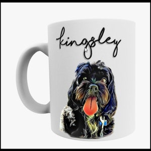 May include: White ceramic mug with a black and white illustration of a dog with its tongue sticking out. The text "kingsley" is written in black cursive on the mug.