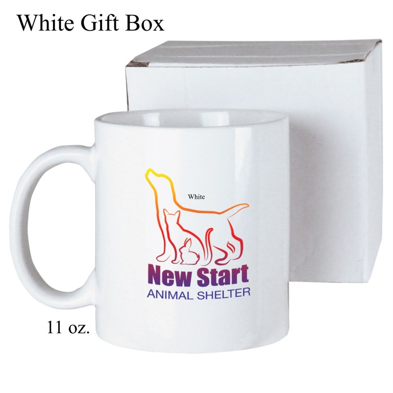 May include: White ceramic mug with a colorful graphic of a dog, cat, and rabbit. The graphic says "New Start Animal Shelter". The mug is 11 oz. and comes in a white gift box.