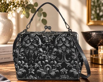 May include: A structured handbag featuring a black and grey damask pattern. The bag has a metal frame with a kiss-lock closure, a single top handle, and a detachable shoulder strap. The hardware is dark metal, and the design is symmetrical.