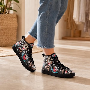 May include: High-top sneakers featuring a black and gray checkered pattern overlaid with a colorful print of playing cards, pocket watches, and keys. The shoes have black laces, black eyelets, and a solid black rubber sole and toe cap.