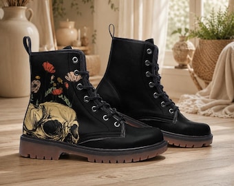 May include: A pair of black lace-up boots featuring a graphic print of a human skull with red and orange poppies growing from the top. The boots have a rounded toe, silver-toned metal eyelets, black laces, and a thick, translucent brown rubber sole.