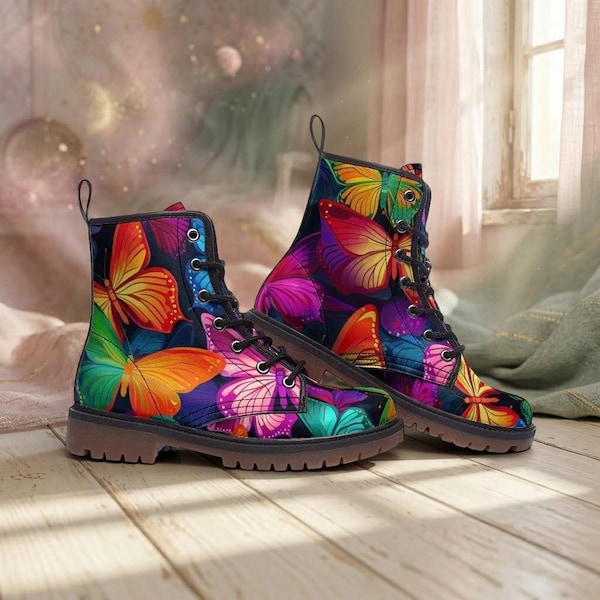 May include: A pair of ankle-high lace-up boots featuring a vibrant, multi-colored butterfly pattern against a dark background. The boots have black laces, silver-toned metal eyelets, and a thick, textured brown sole with a defined heel.