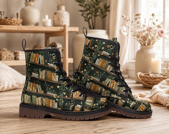 May include: A pair of black lace-up boots with a unique bookshelf design. The boots feature a dark green background with images of bookshelves filled with books and floral accents. The boots have a brown sole and are displayed on a wooden surface.