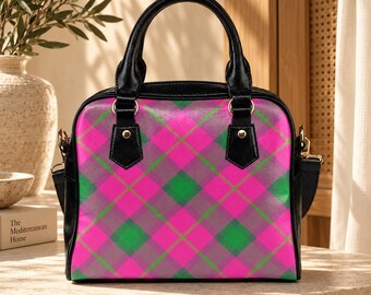 May include: A structured handbag featuring a vibrant diagonal plaid pattern in shades of hot pink, forest green, and grey. The bag includes black leather handles, black side panels, gold-toned metal hardware, and a detachable shoulder strap.