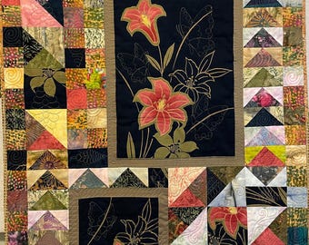 May include: A quilt with a patchwork design featuring a variety of fabrics in shades of brown, green, pink, and red. The quilt is made up of squares and triangles, and it features a floral pattern in the center.