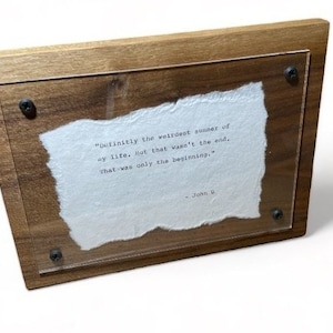 May include: A wooden framed quote with a white paper insert. The quote reads "Definitely the weirdest summer of my life, not that wasn't the end, that was only the beginning." - John G.