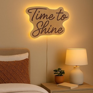 May include: A wooden sign with the words "Time to Shine" in a cursive font, illuminated with a warm glow. The image shows a bedside table with a lamp and a small potted plant, creating a warm and inviting atmosphere.